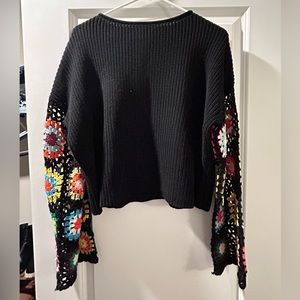 Black sweater with wide arm sleeves